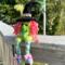 Witch.  Nellie the rainbow witch sits on balcony outside